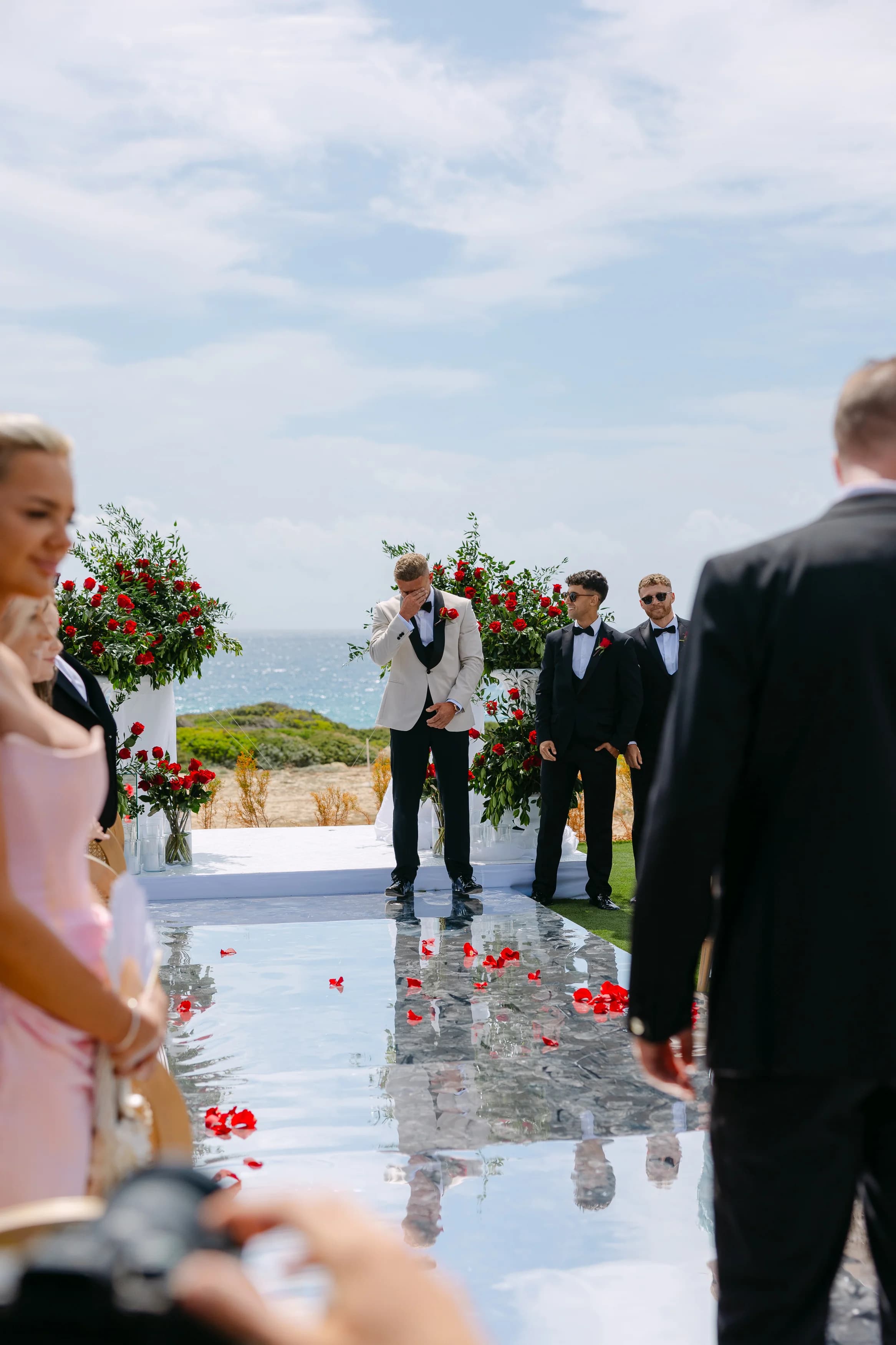 Groom reacting emotionally at the altar at Ozea as the bride begins her walk down the aisle.