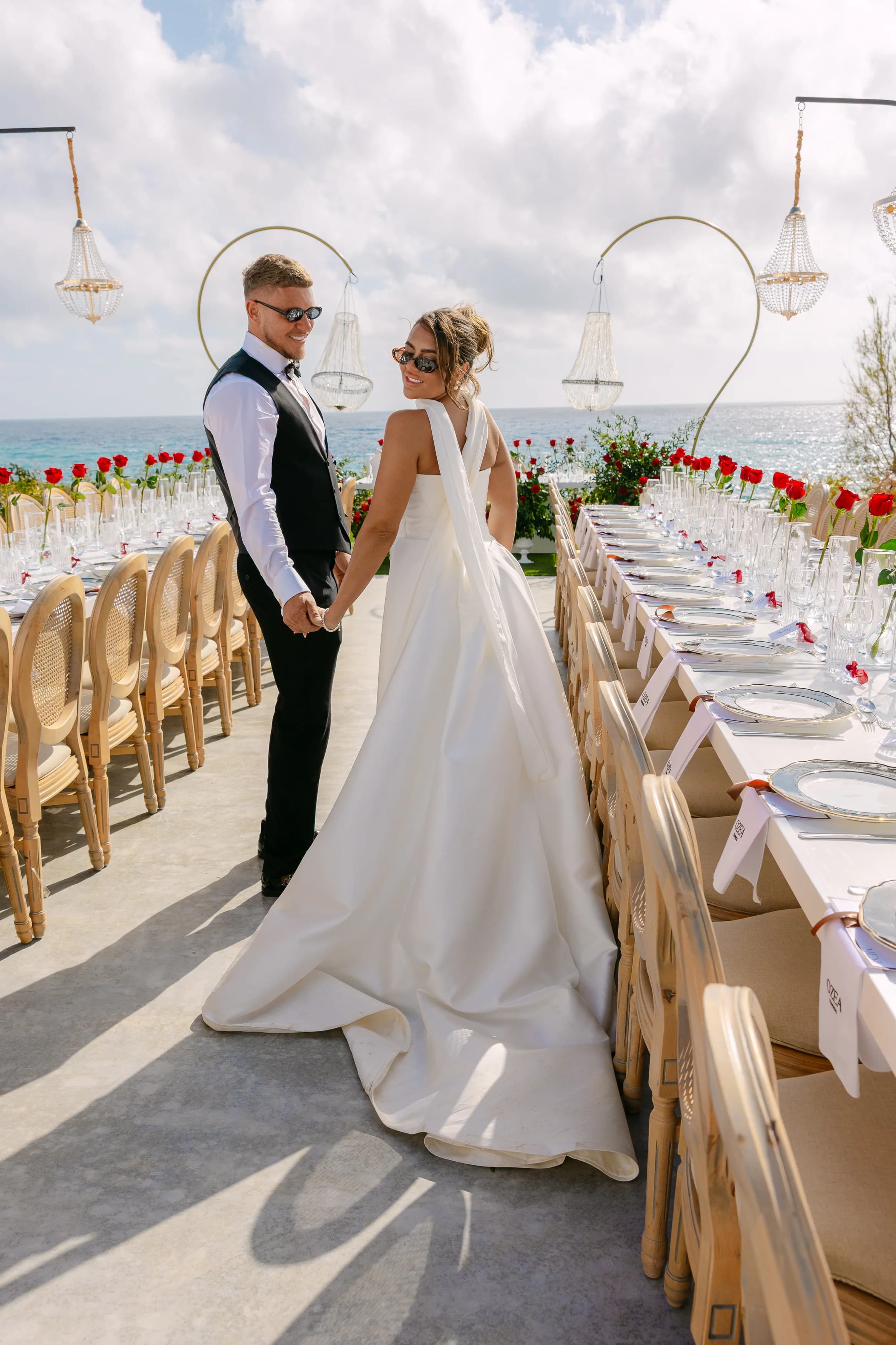 Bride and groom walking together past the banquet tables at Ozea.