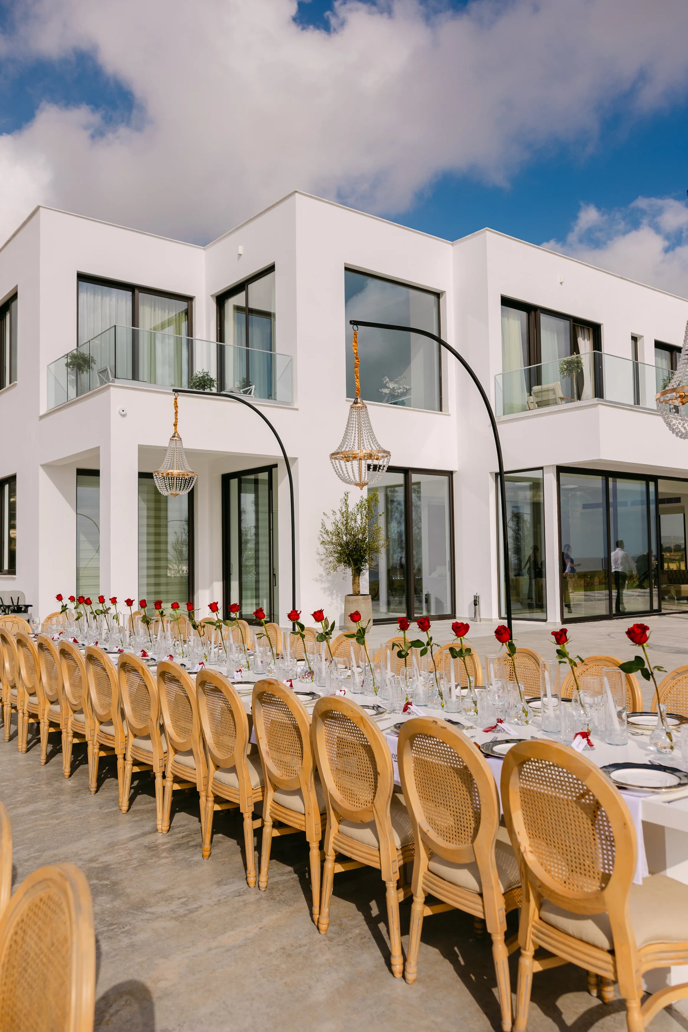 Exterior of the villa at Ozea with a long banquet table styled along the terrace.