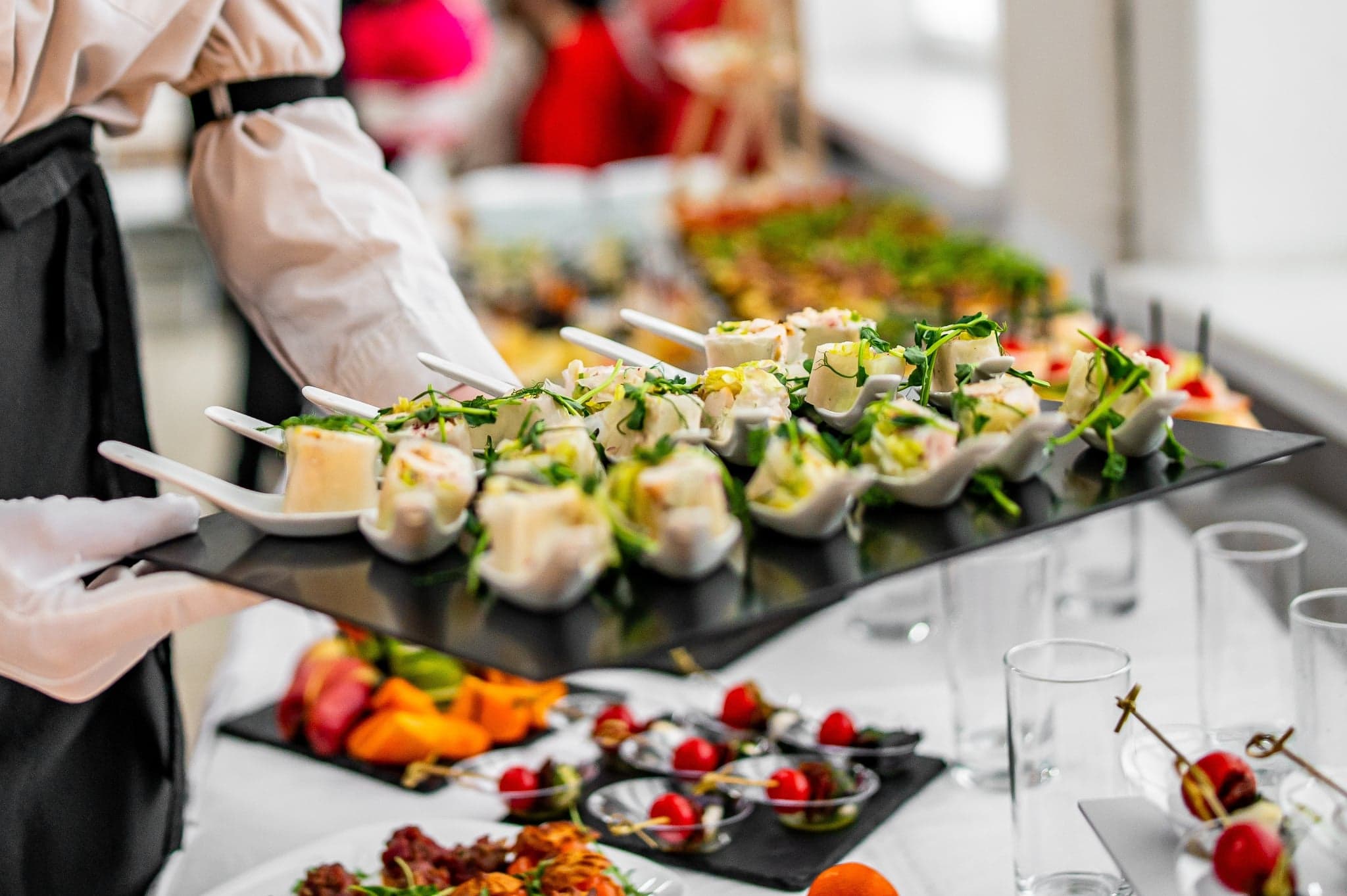 Chef-led canapé service at OZEA with plated bites prepared in front of guests.
