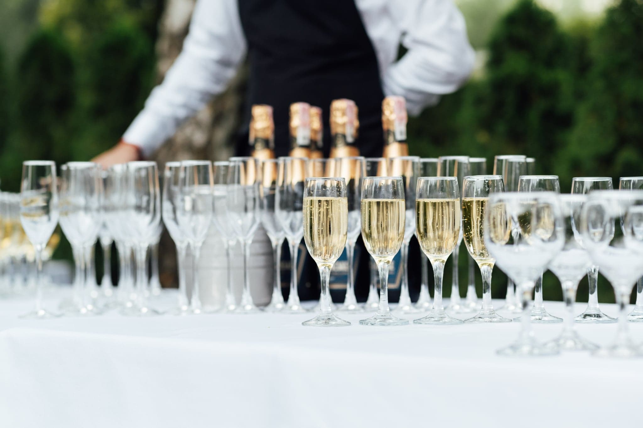 Champagne glasses lined up for wedding drinks service at OZEA.