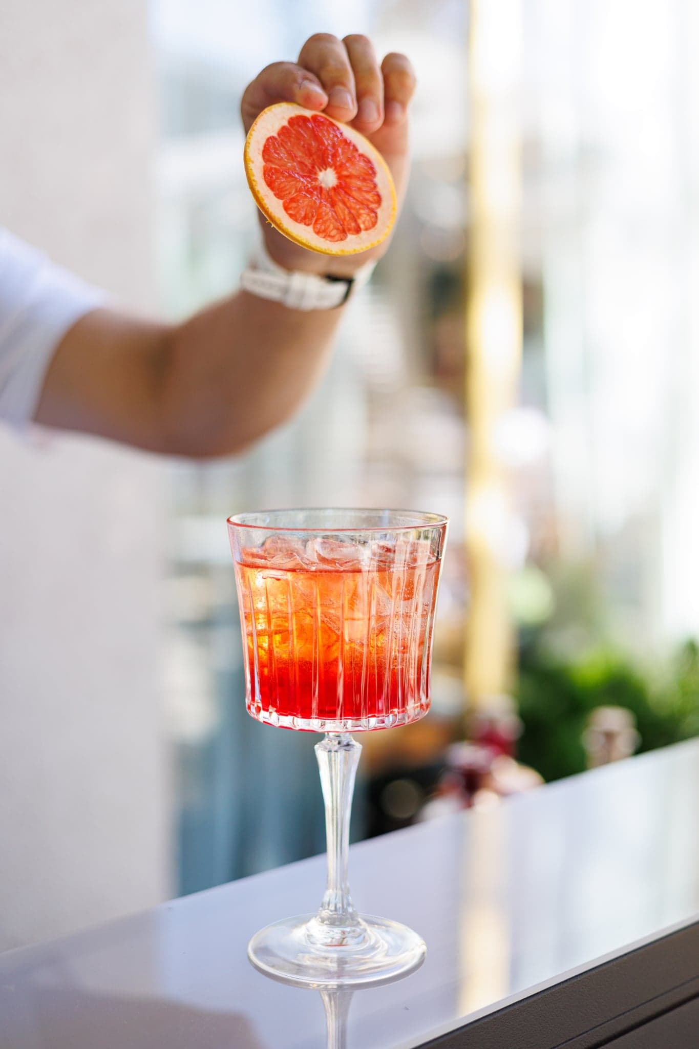 Signature cocktail close-up with citrus garnish served at OZEA.