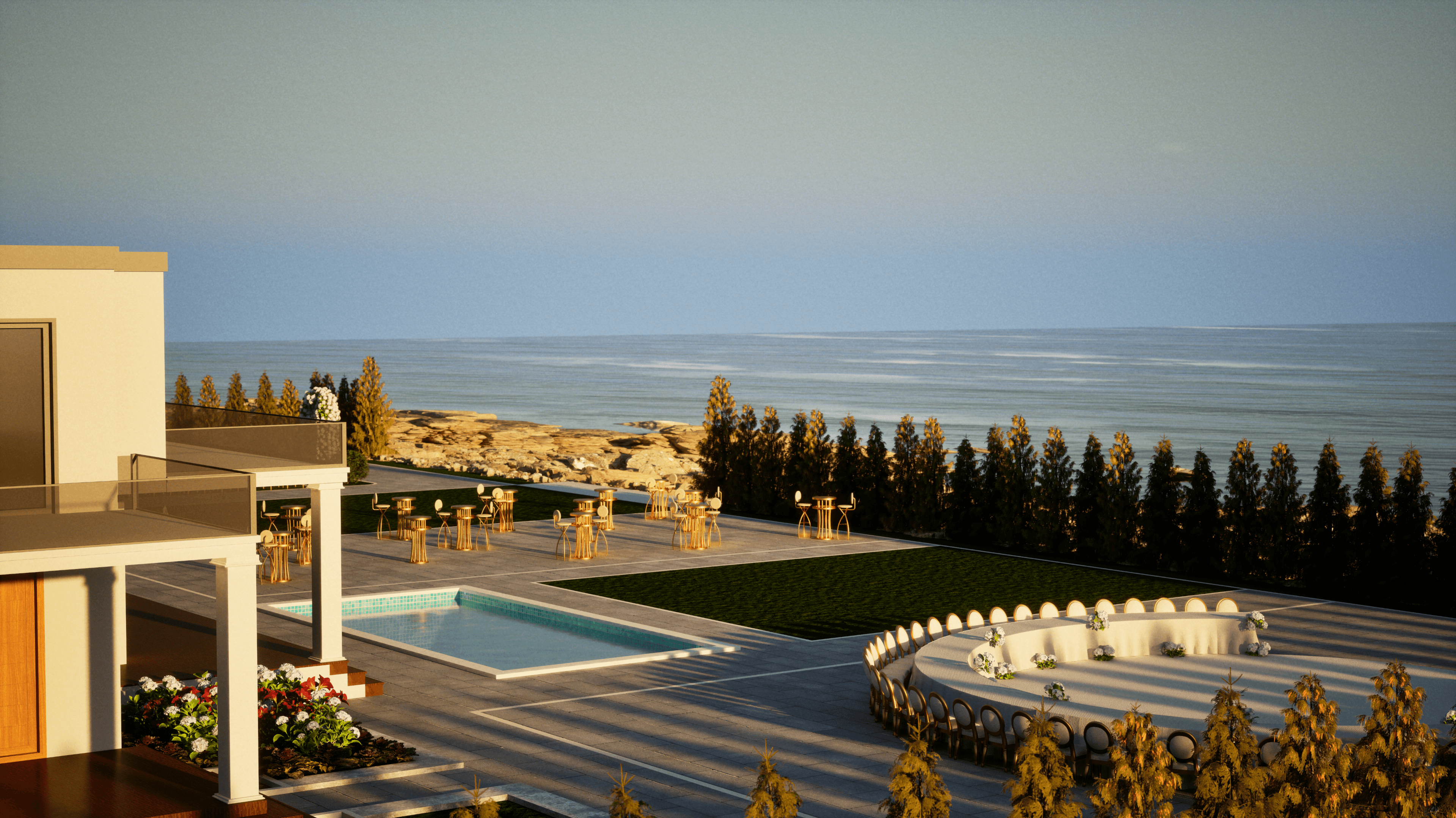 Evening view of the dining terrace at OZEA with warm light and the coastline beyond.